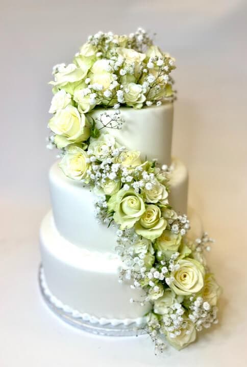 Bryllupskake i etasjer med friske blomster